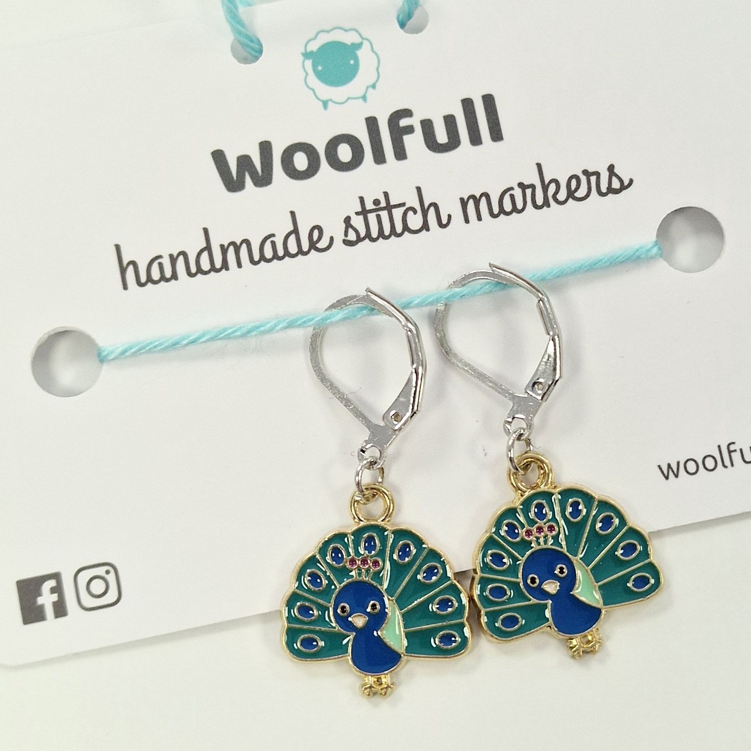 2 blue and green peacock shaped stitch markers.