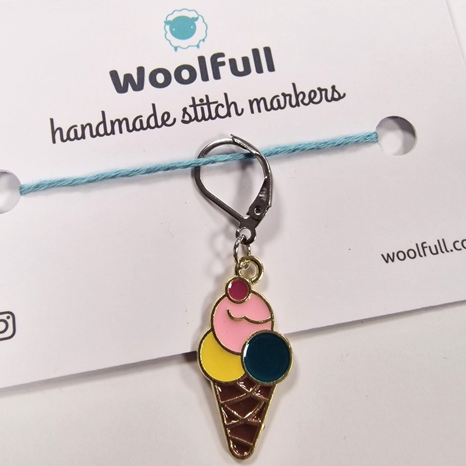 An enamel ice cream shaped stitch marker.
