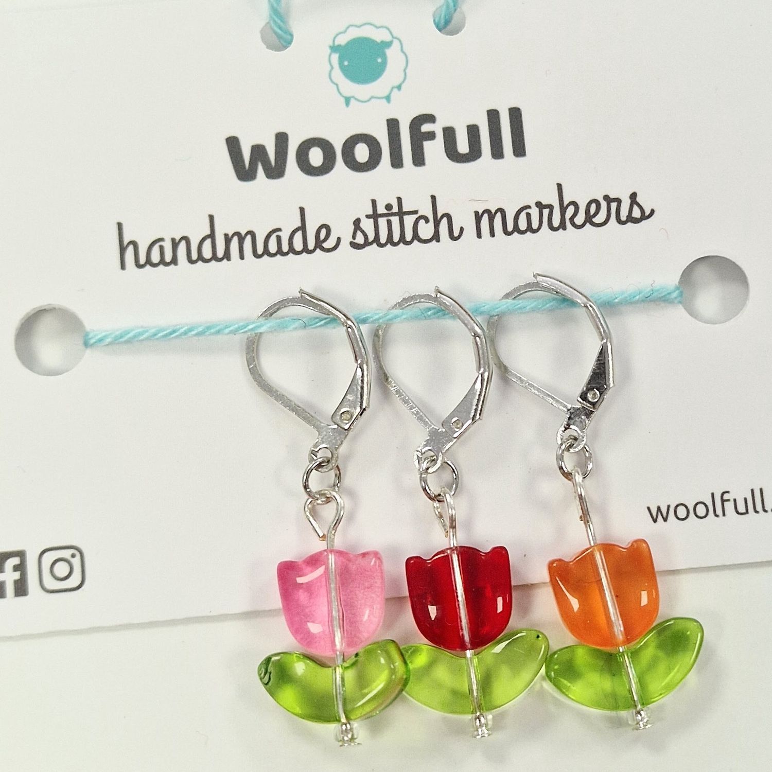 3 tulip shaped stitch markers in pink, red and orange.