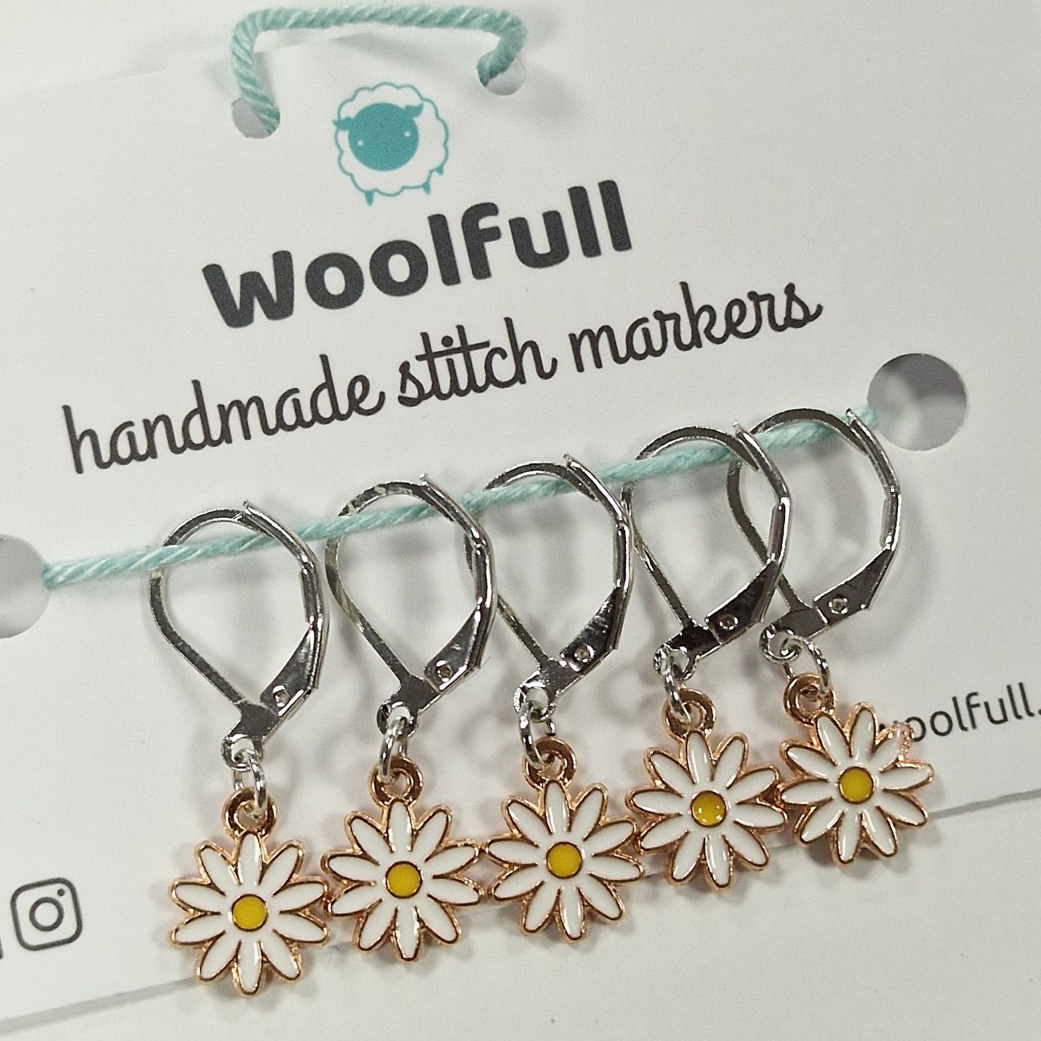 5 metal daisy shaped stitch markers.