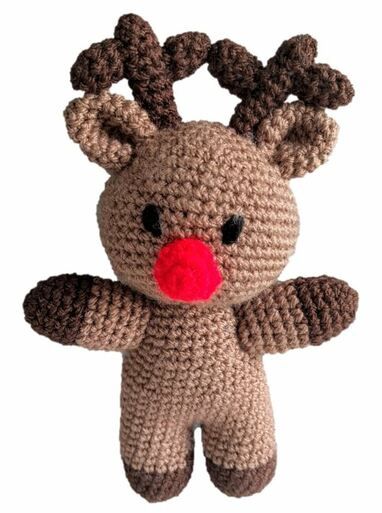 A brown crocheted reindeer toy with a red nose.