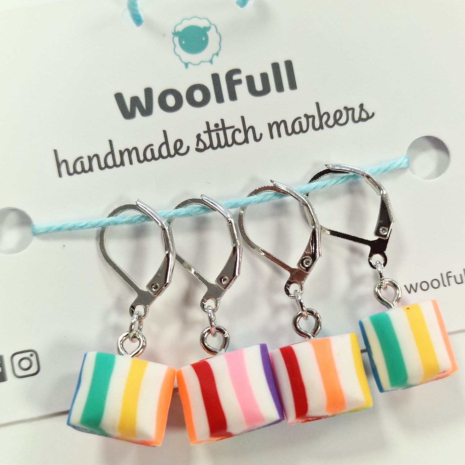 4 striped rainbow rock stitch markers.