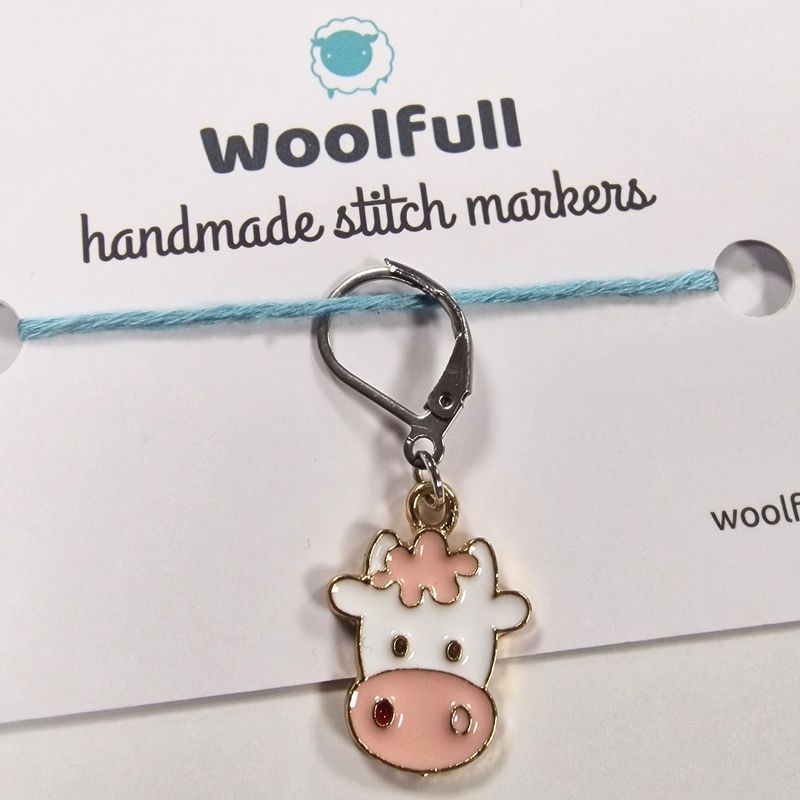 An enamel cow shaped stitch marker.