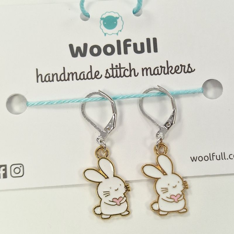 2 white bunny shaped stitch markers.
