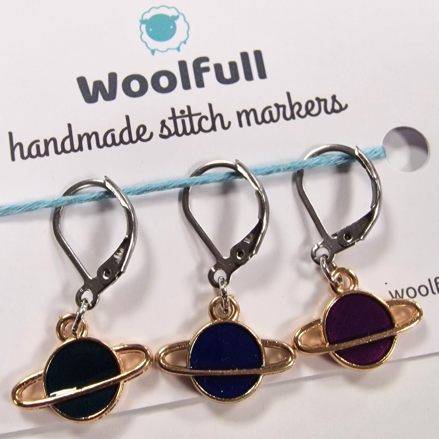 3 planet shaped stitch markers.