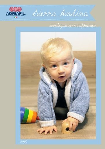 A baby is wearing a blue and white knitted hooded coat.