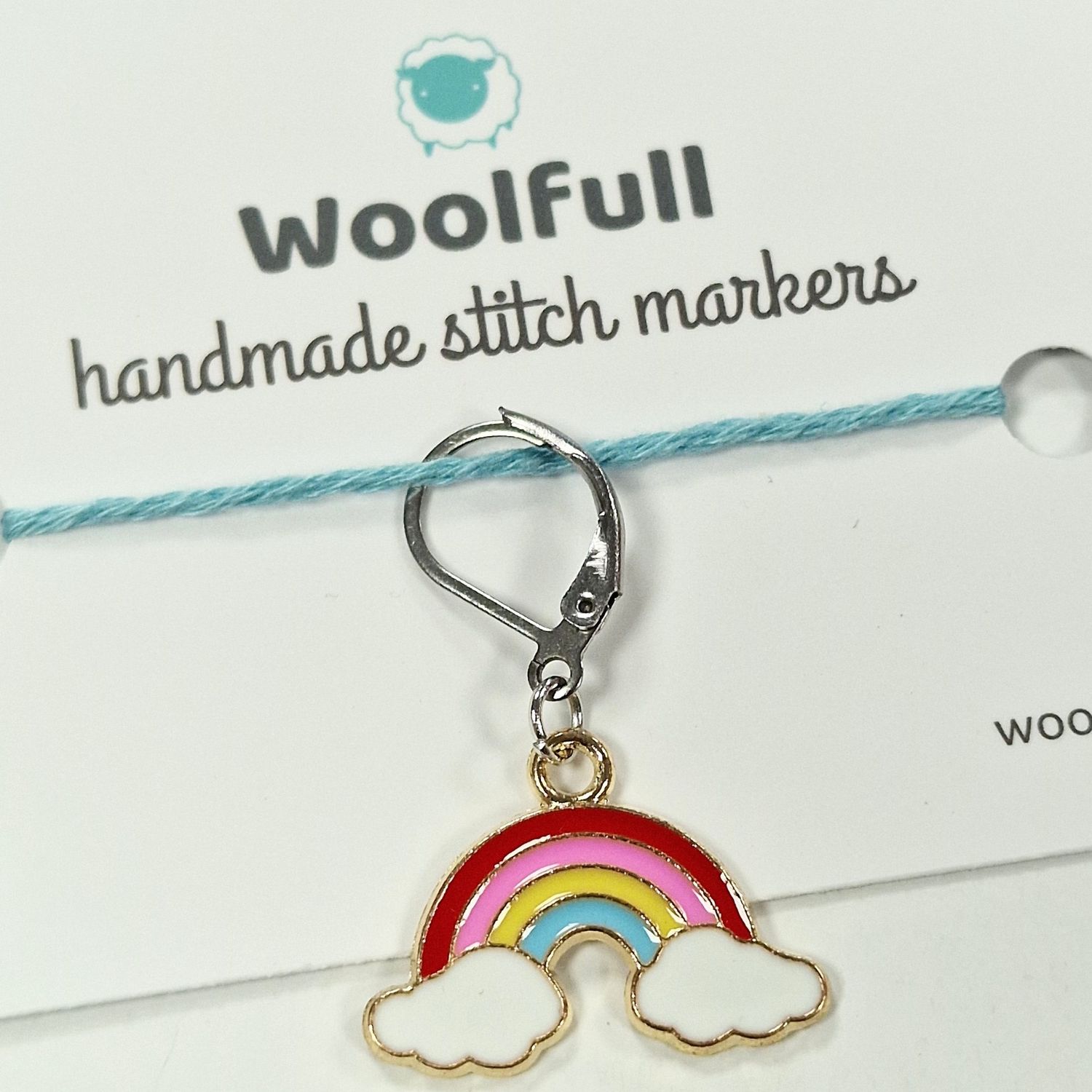 A rainbow coloured and shaped stitch marker.
