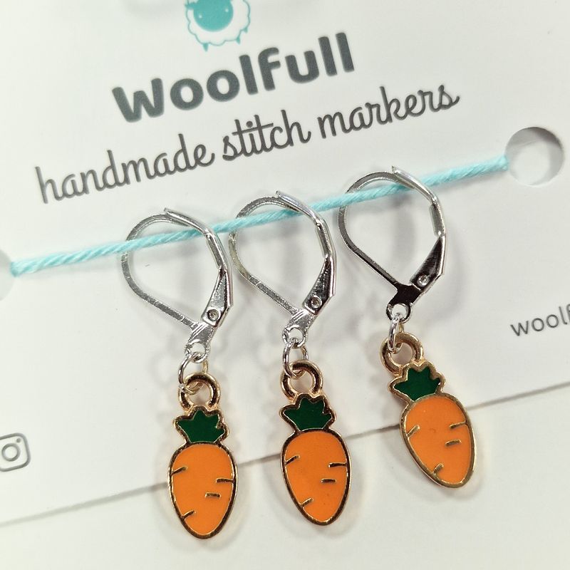 3 carrot shaped stitch markers.

