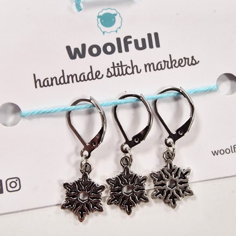 3 snowflake shaped stitch markers.
