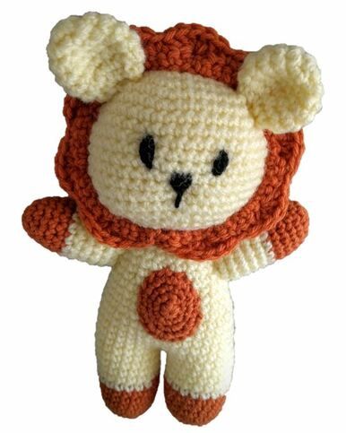A yellow and orange crocheted lion toy.