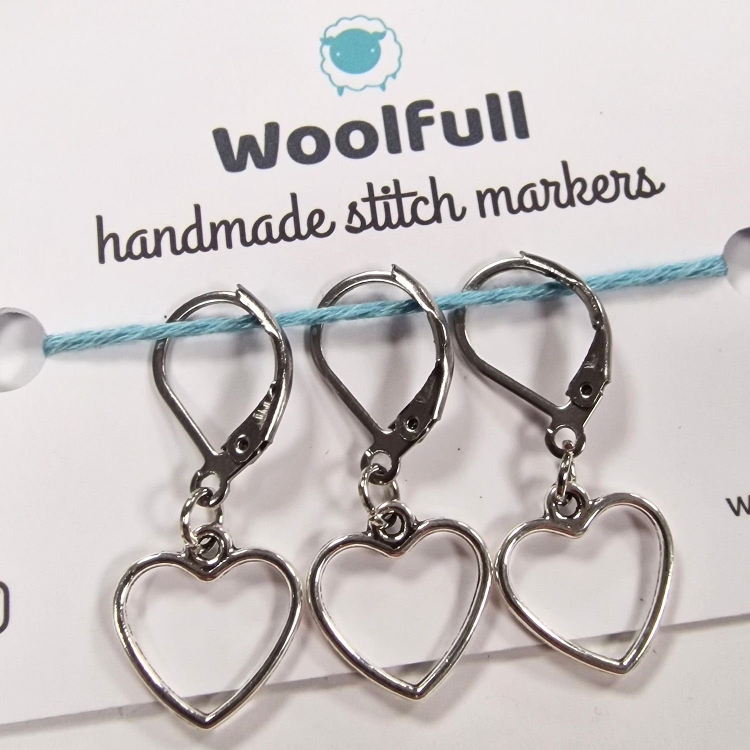 3 silver metal heart shaped stitch markers.