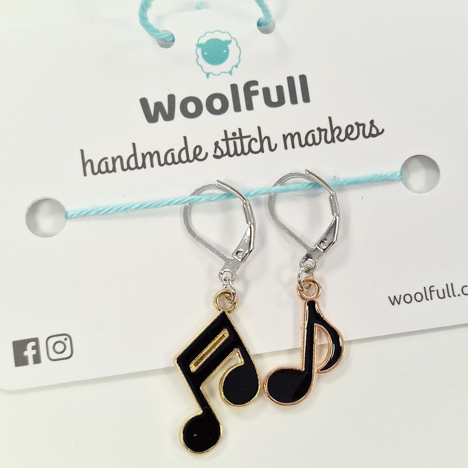 2 black music note shaped stitch markers.