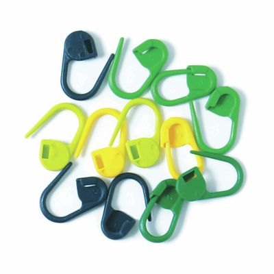 Several locking stitch markers in blue, yellow and green.