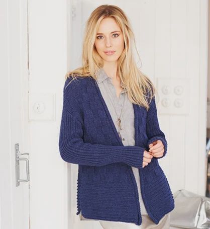 A woman is wearing a navy blue knitted cardigan.