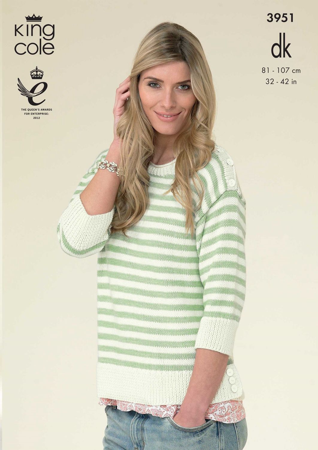 A woman is wearing a cream and green striped knitted sweater.