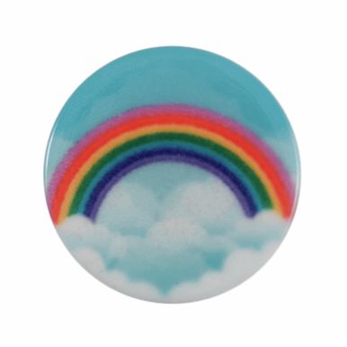 A round button with a picture of a rainbow against a blue sky.