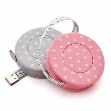 2 retractable polka dot tape measures, 1 grey and 1 pink.