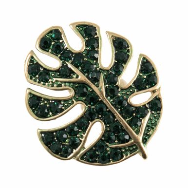 A dark green glittery monstera leaf shaped button.