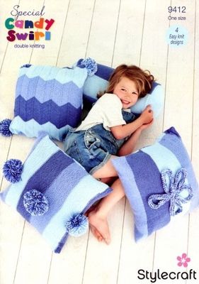 A girl is surrounded by 4 blue stripy knitted cushions.