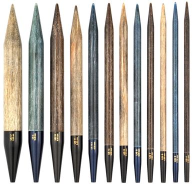 Several interchangeable knitting needle tips in browns and blue.