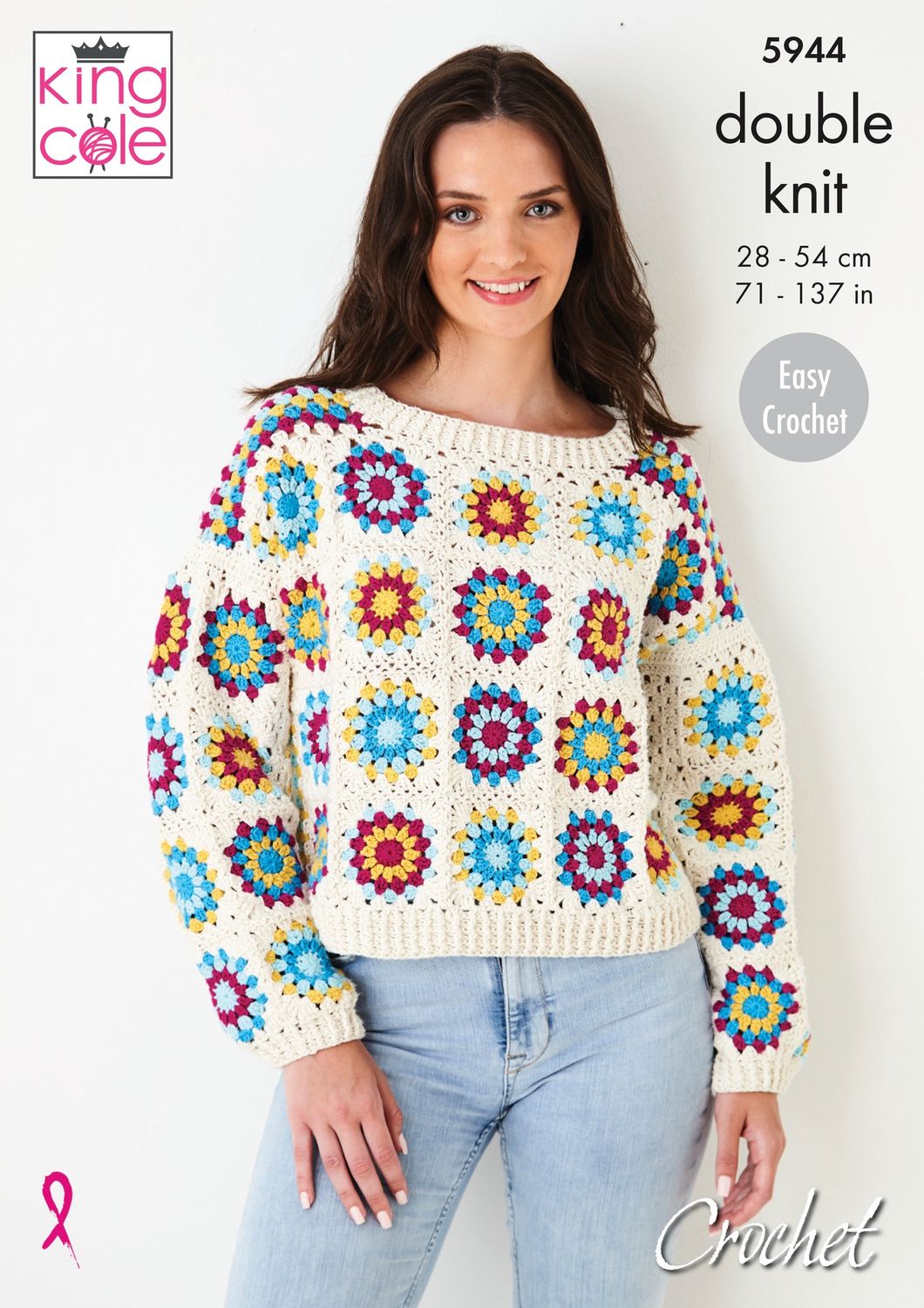 A woman is wearing a crocheted jumper, made of multicoloured granny squares that are all bordered and joined in cream.