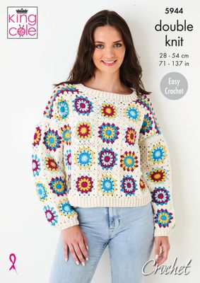 A woman is wearing a crocheted jumper, made of multicoloured granny squares that are all bordered and joined in cream.