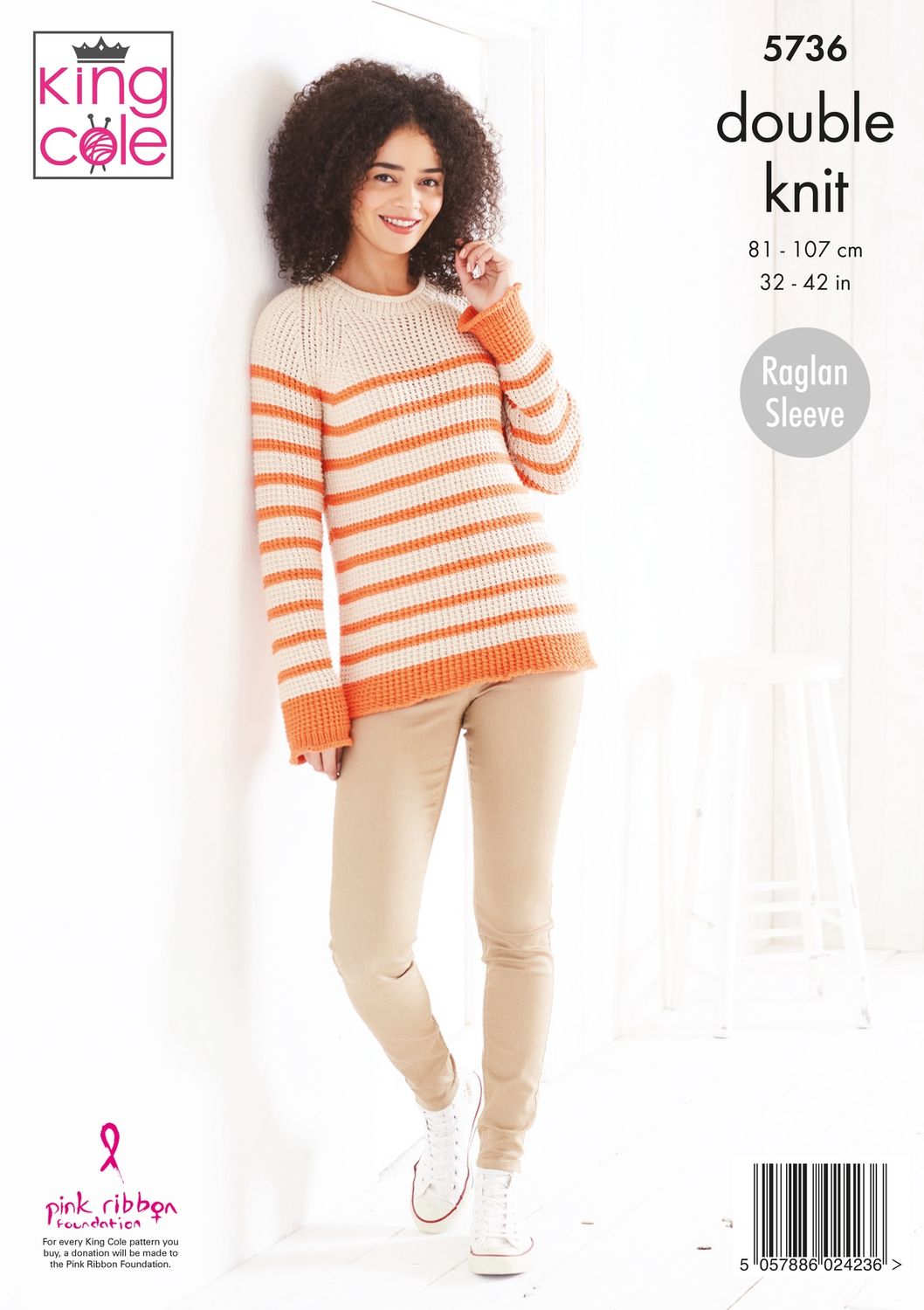 A woman is wearing a cream and peach striped knitted sweater.