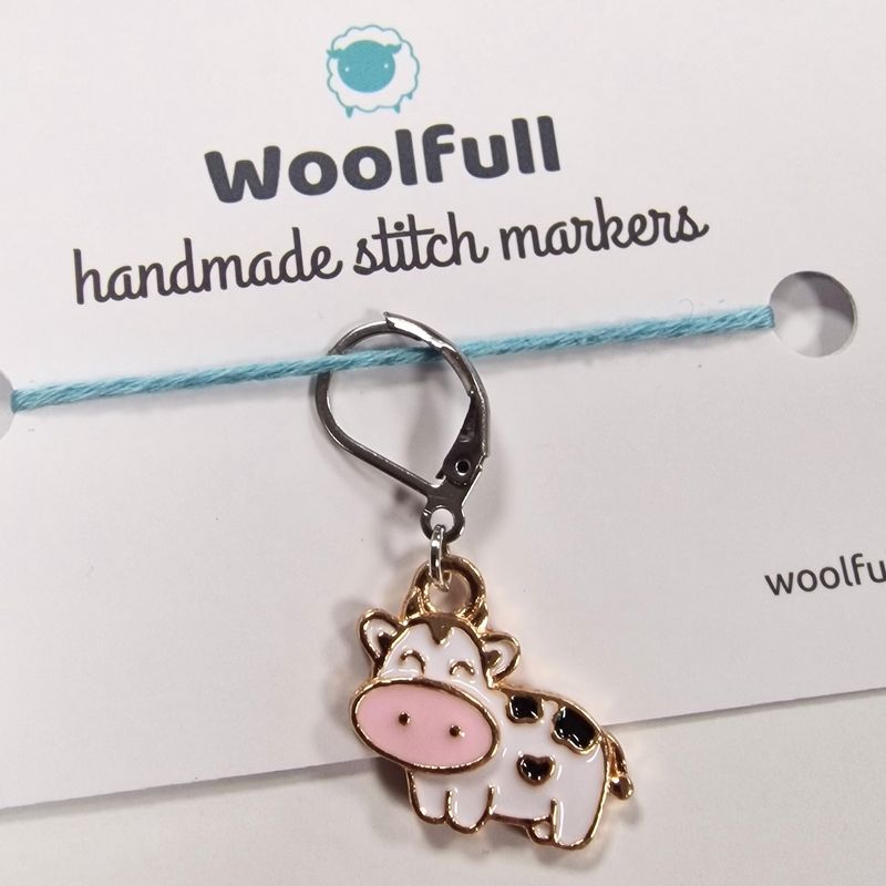 An enamel cow shaped stitch marker.