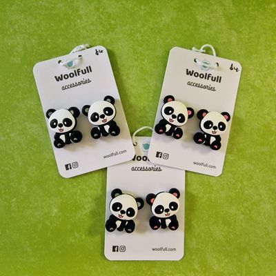 A green background with 3 pairs of panda shaped point protectors mounted on a white card.