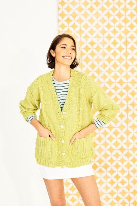 A woman is wearing a lime green knitted cardigan.