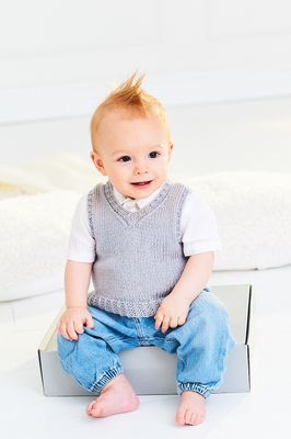 A baby is wearing a knitted grey tank top.