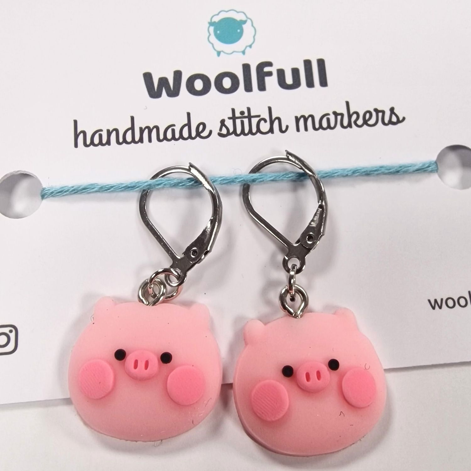 2 pink pig shaped stitch markers.