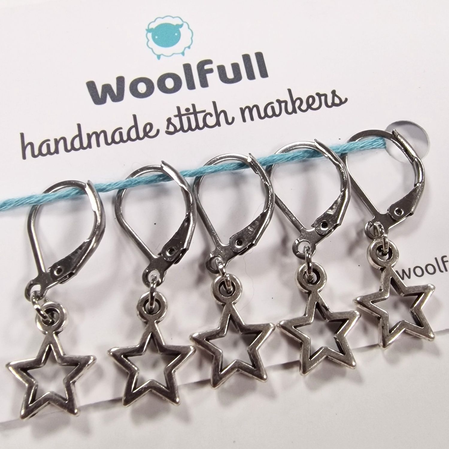 5 silver metal star shaped stitch markers.