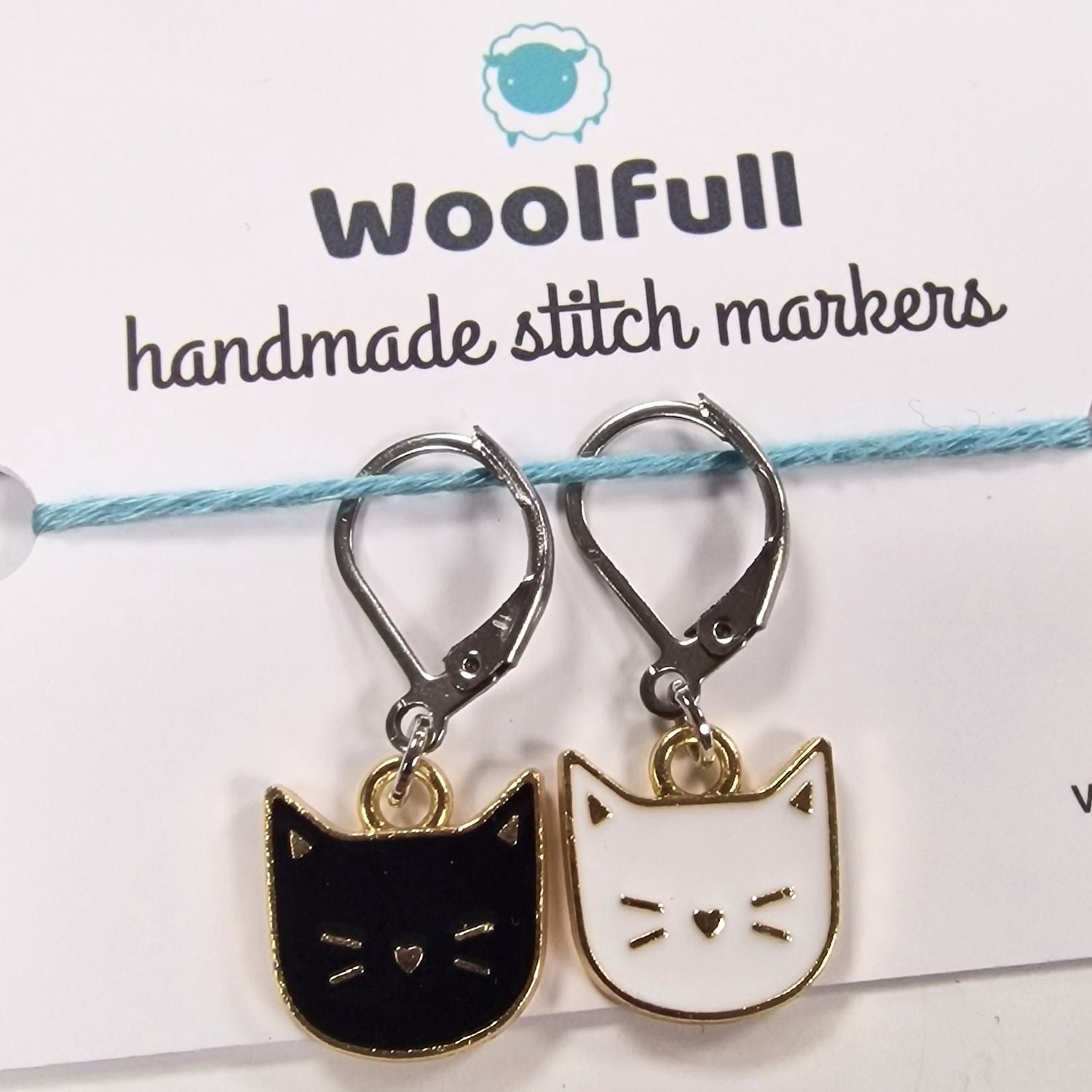2 cat shaped stitch markers, 1 black and 1 white.