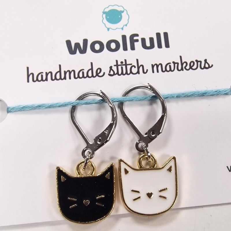 2 cat shaped stitch markers, 1 black and 1 white.