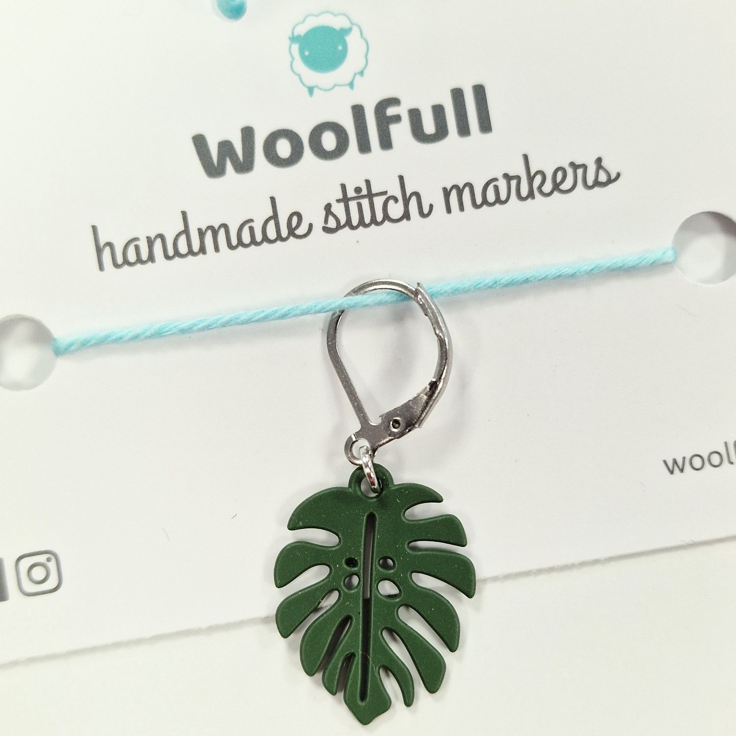 A monstera leaf shaped stitch marker.