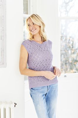 A woman is wearing a light purple knitted lace top.