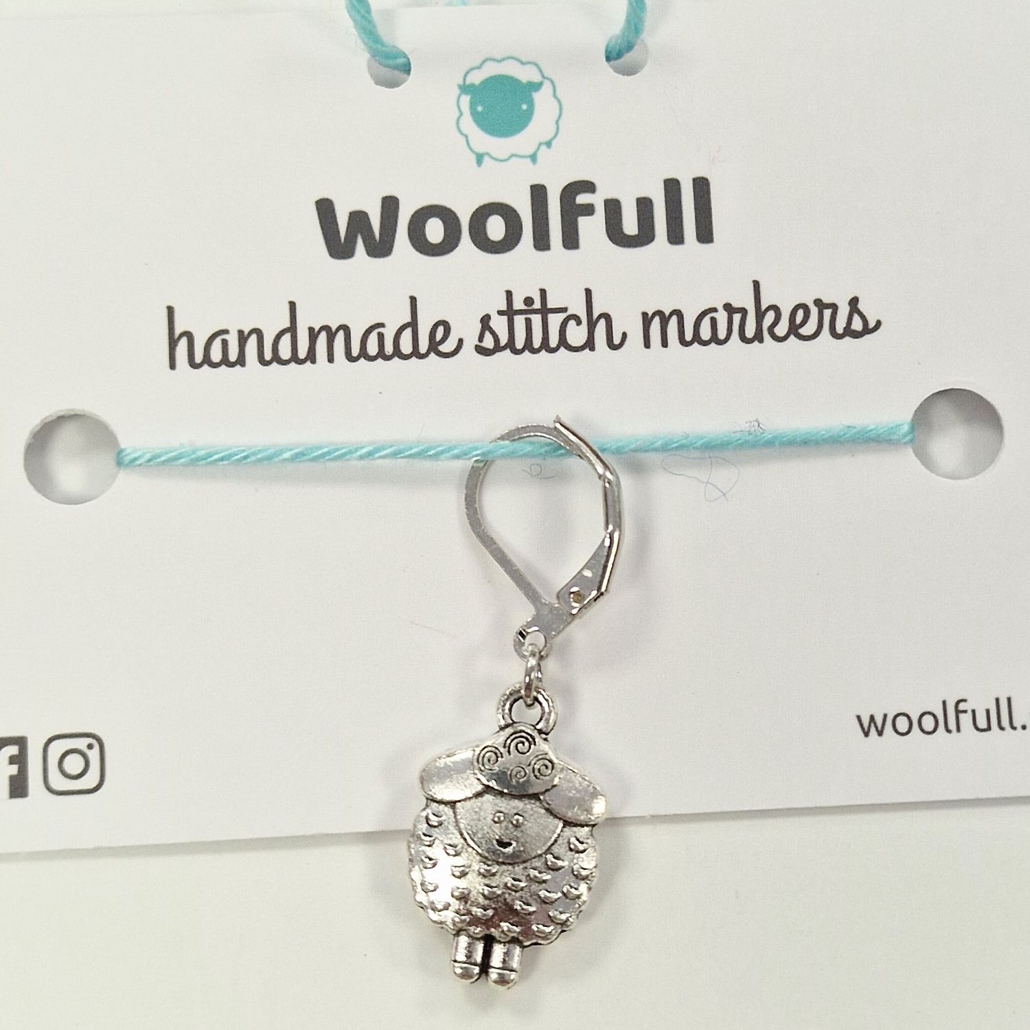 1 silver metal shaped stitch marker.