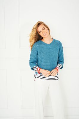 A woman is wearing a blue knitted sweater.