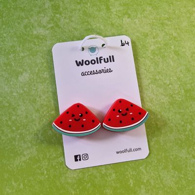 A green background with a pair of watermelon shaped point protectors mounted on a white card.