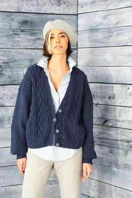 A woman is wearing a navy blue knitted cardigan.