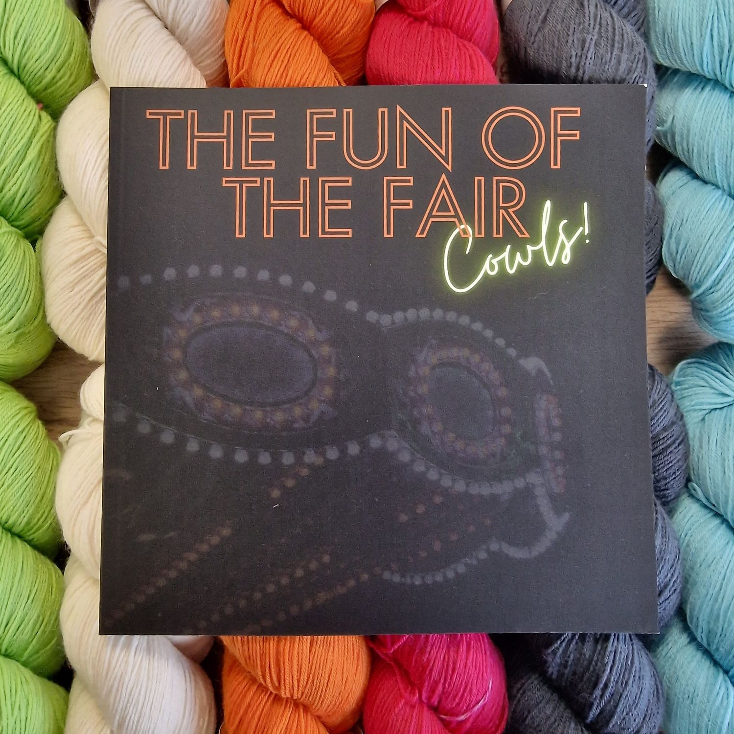 The front of the book on a background of brightly coloured skeins.

