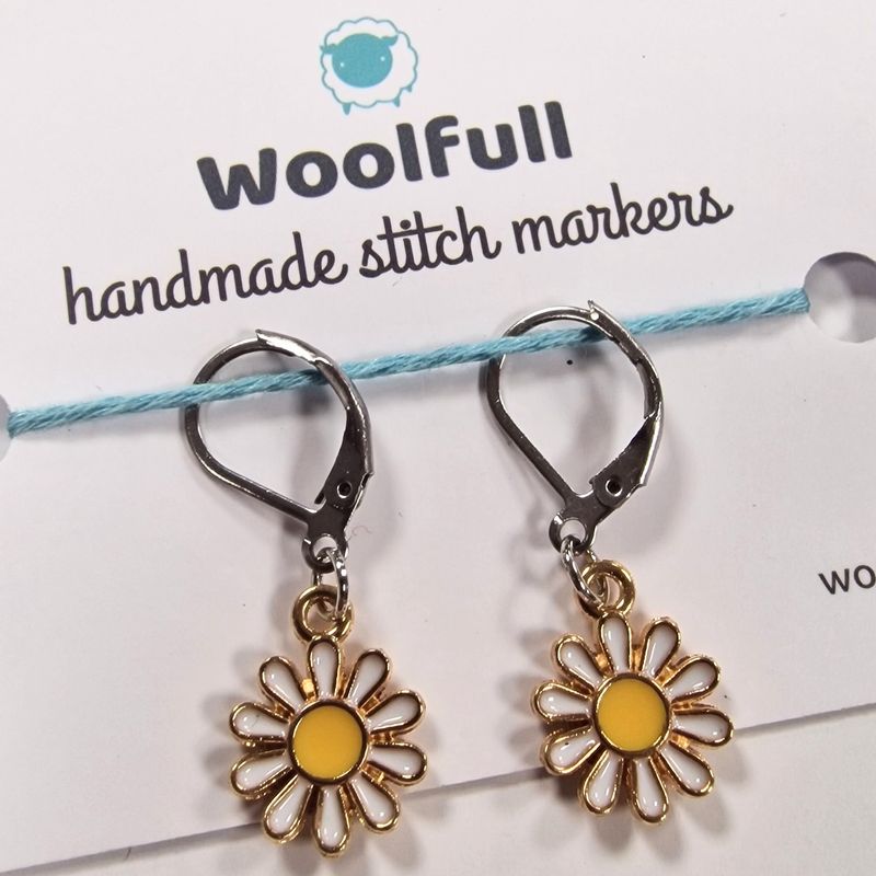 2 metal daisy shaped stitch markers.
