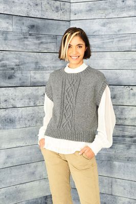 A woman is wearing a grey knitted tank top.