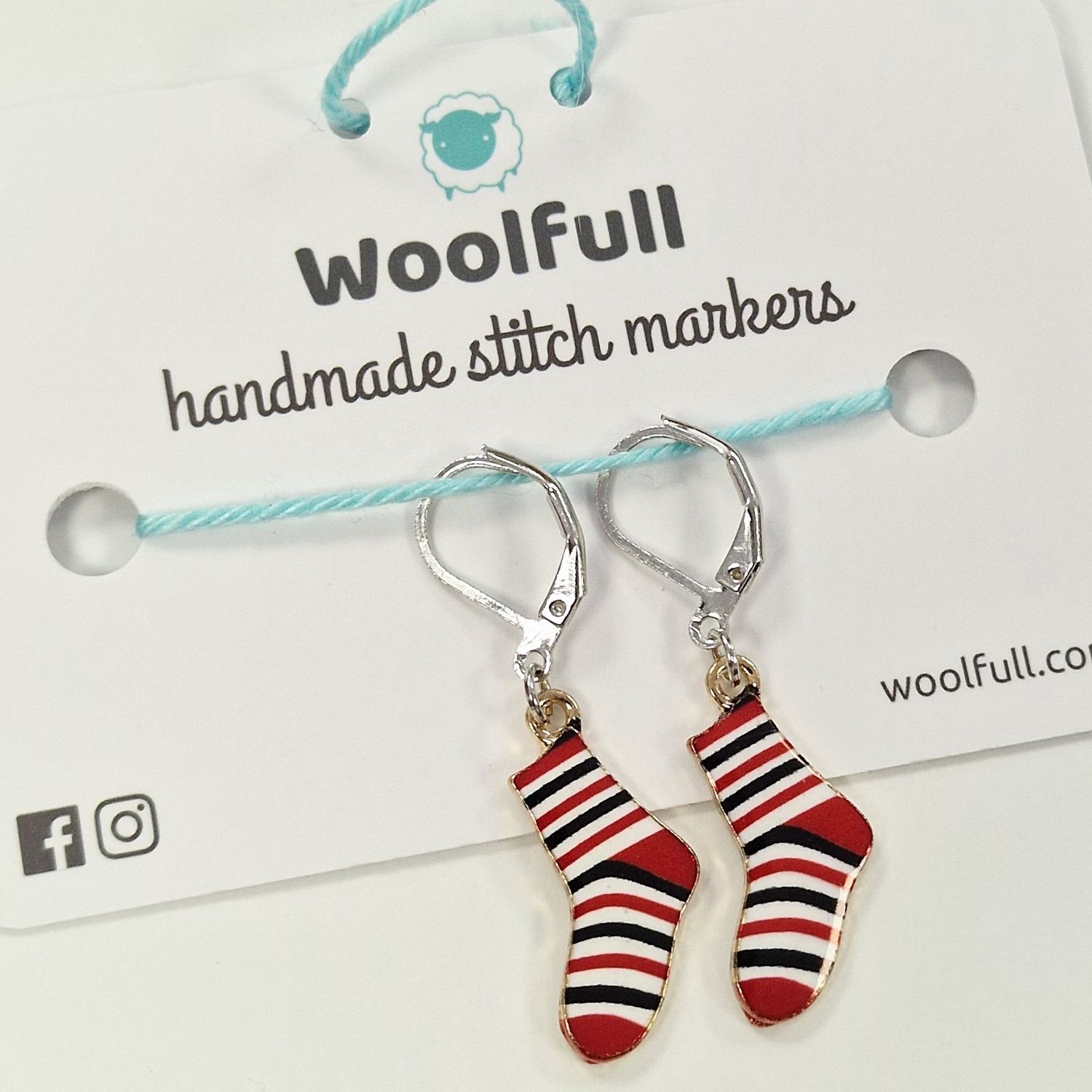 2 red, white and blue sock shaped stitch markers.