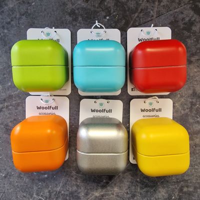 6 brightly coloured stitch marker storage cubes. They are green, blue, red, orange, silver and yellow.