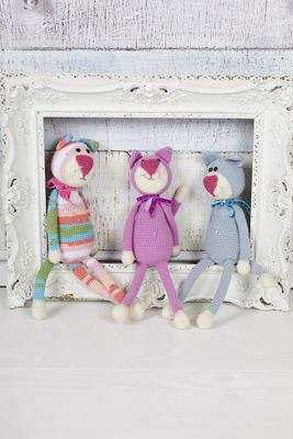 3 crocheted toy cats, 1 in a variegated yarn, 1 pink and 1 grey.