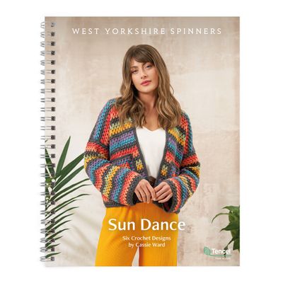 The front cover of the Sun Dance pattern book. On it, a woman is wearing a crocheted cardigan in grey, blue, yellow, red, green, purple, orange.