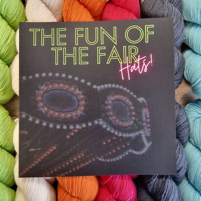 The front of the book on a background of brightly coloured skeins.
