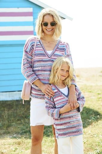 A woman and a girl are wearing matching knitted sweaters in a variegated pink, purple and blue yarn.